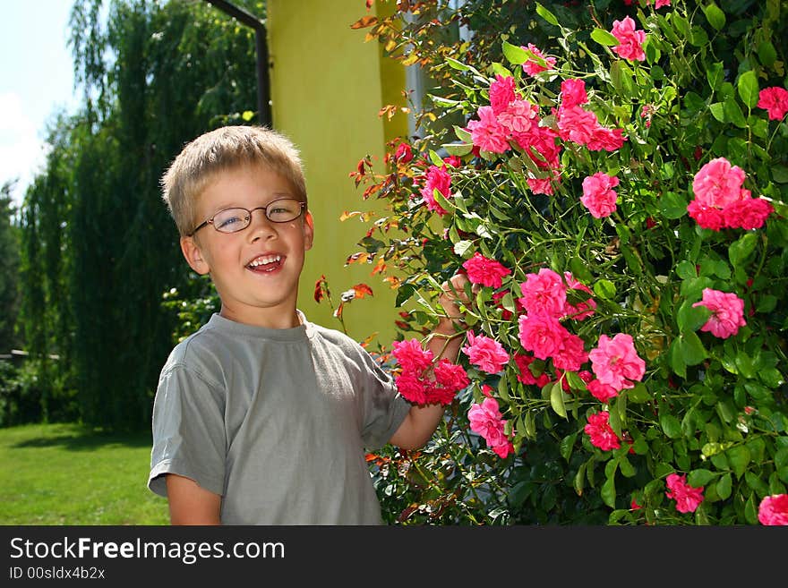 Boy with roses in summer time