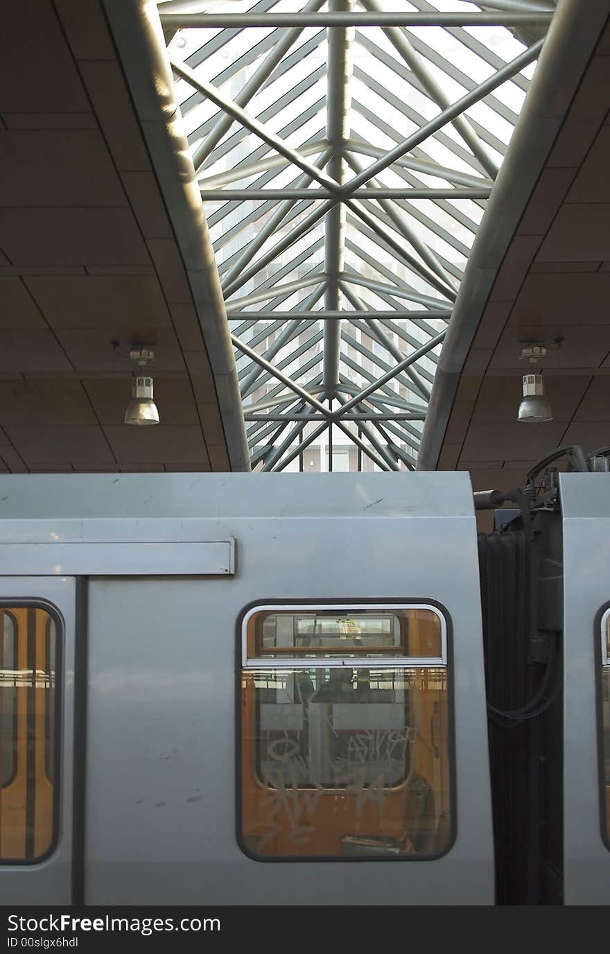 Detail of a metro train with a silhouette of a metro station roof