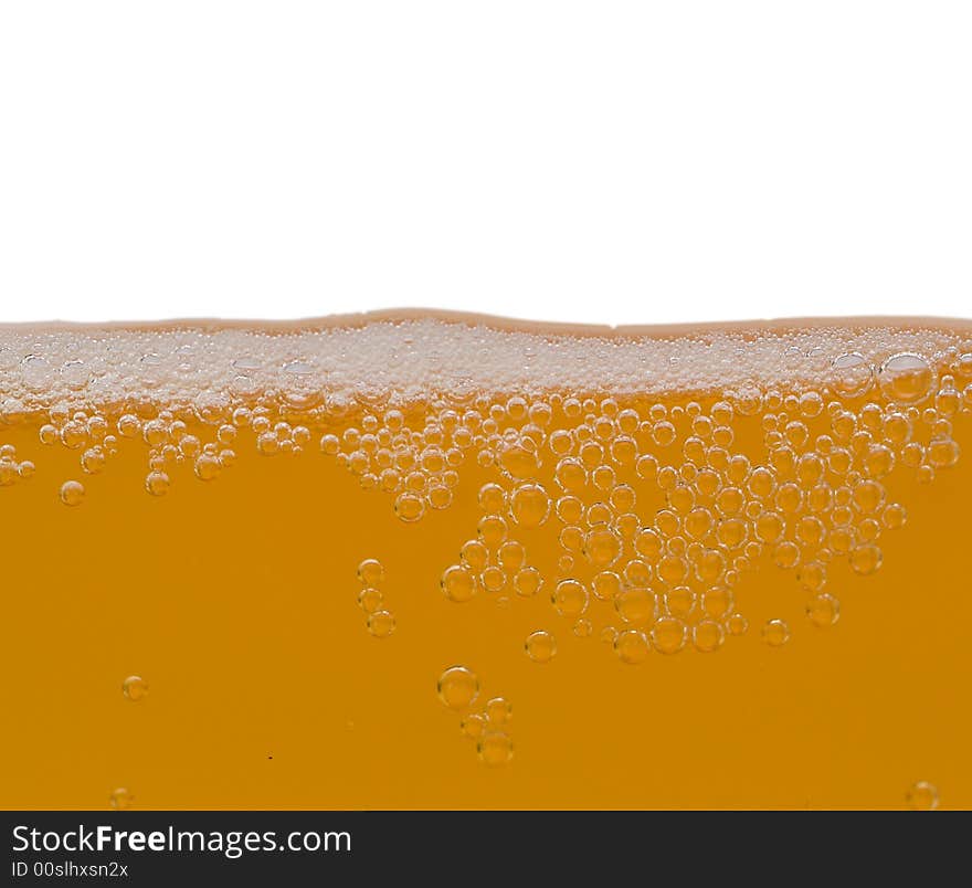 Close-up unfiltered beer with bubbles, isolated on white