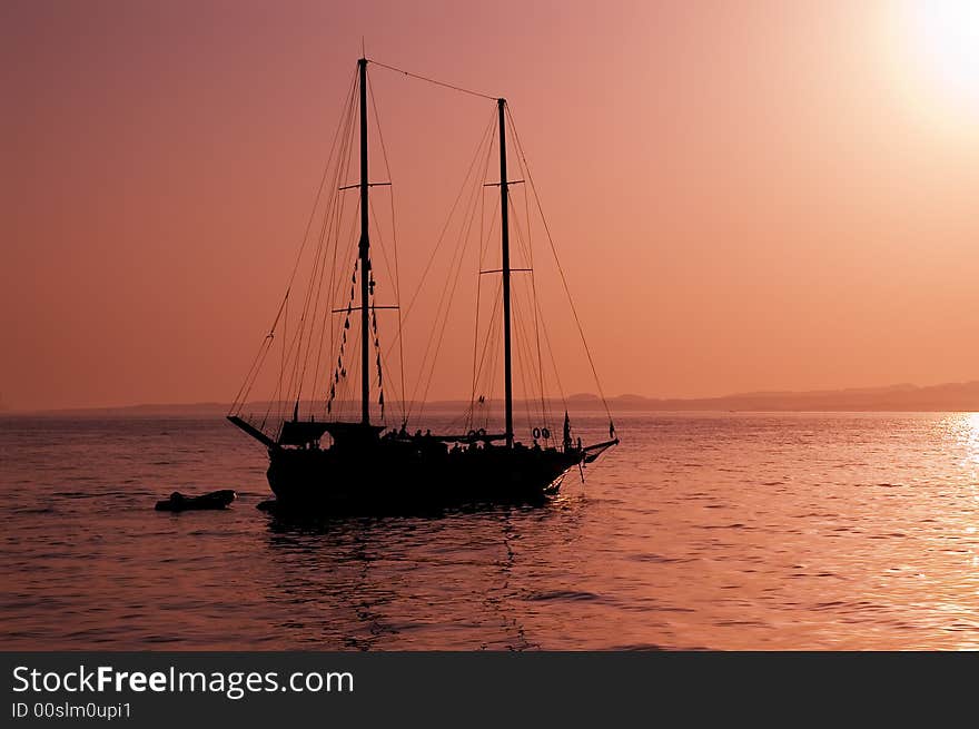 Yacht silhouette and red sunset at Red sea, Egypt