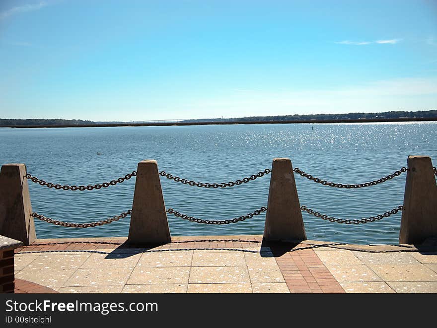 Chained Fence On Shore.