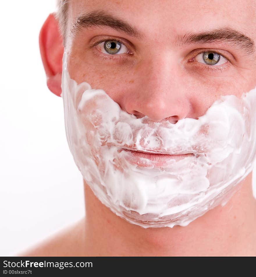 Young man with shaving foam on his face. Young man with shaving foam on his face