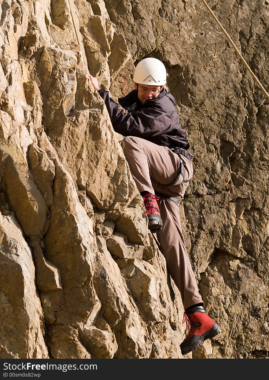 Climber swarming up the rock wall