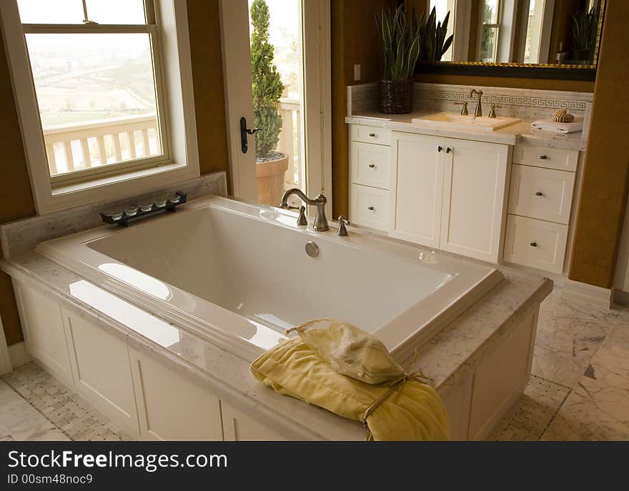 Designer bathroom with a modern tub and tile floor. Designer bathroom with a modern tub and tile floor