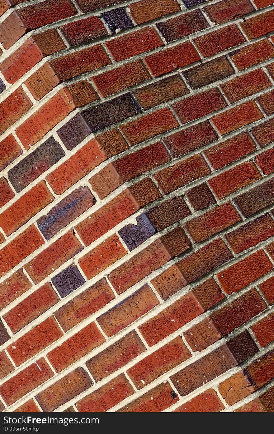 Diagnal view of a red brick wall