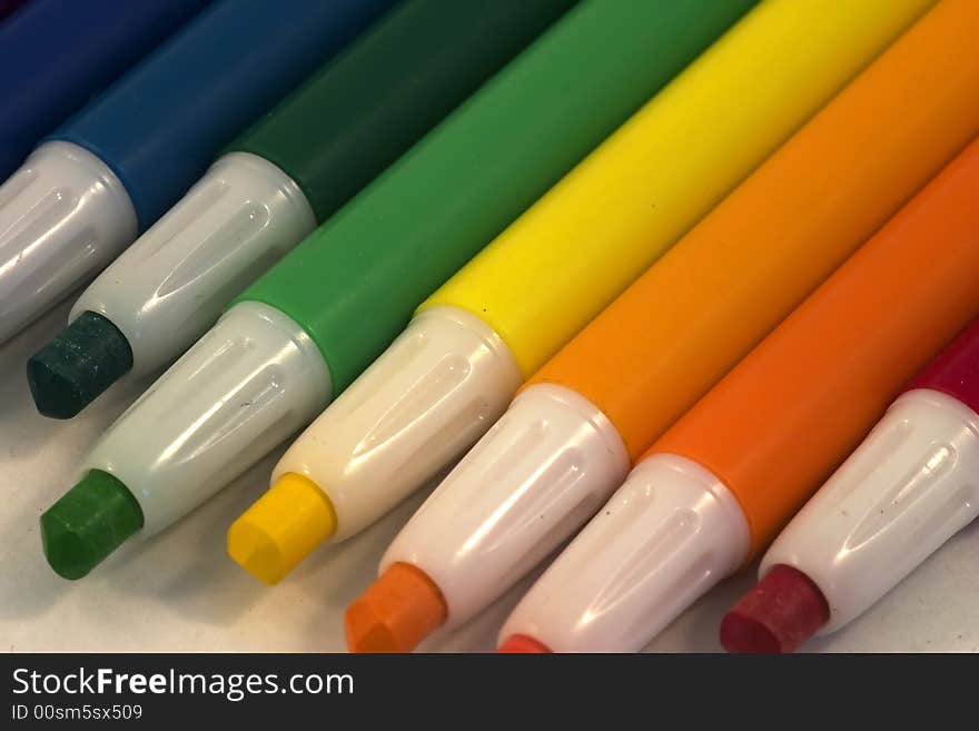 A rainbow gradient of plastic coated crayons. A rainbow gradient of plastic coated crayons