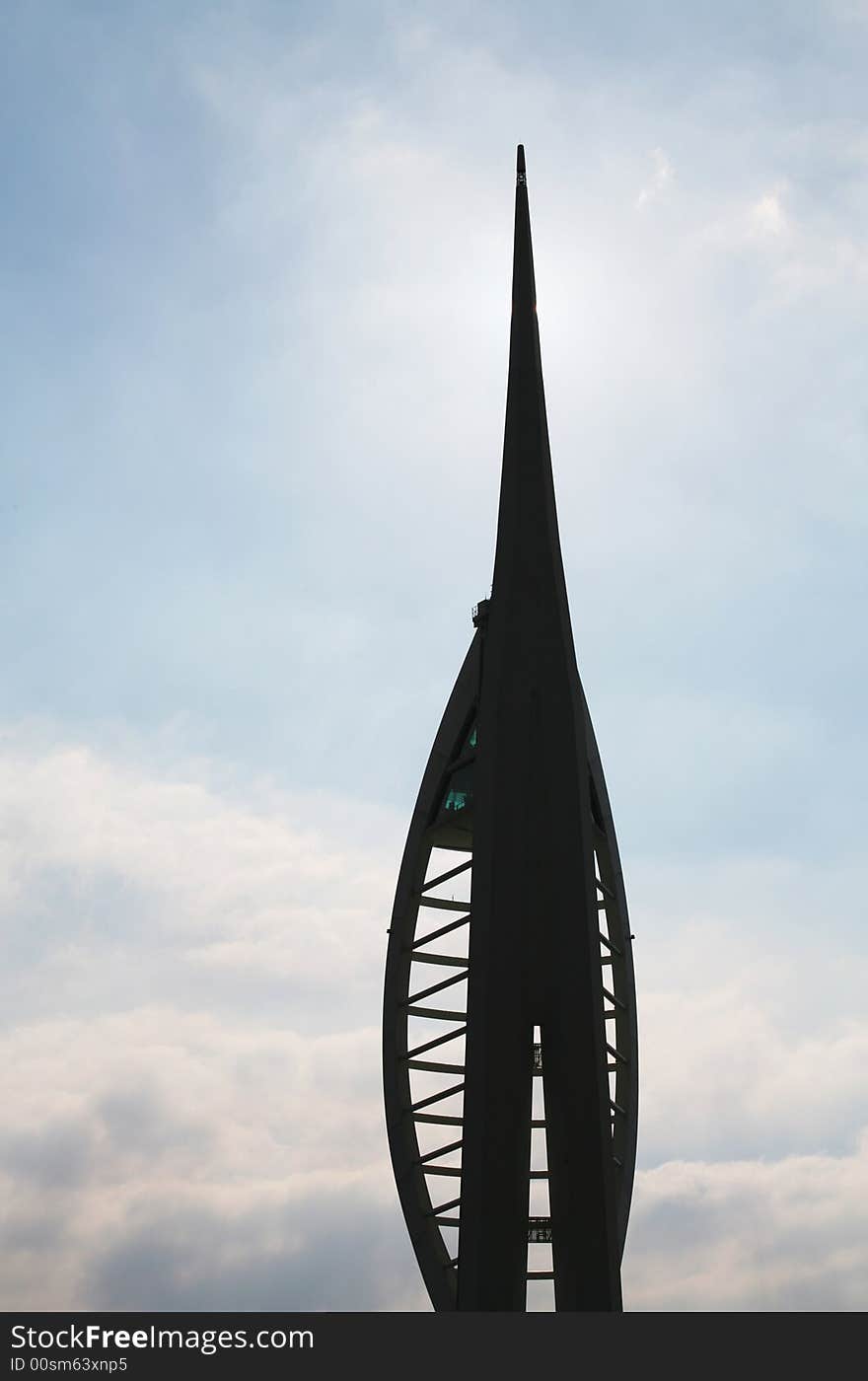 This stock photo depicts a silhouette of the upper portion of the Millenium Spinnaker Tower in Portsmouth, England. The Spinnaker Tower soars 170 meters (557 feet) into the sky above the historic harbour of Portsmouth, gateway to the English Channel.The Tower is a recent addition to the Portsmith city skyline. It can be found in the recently redeveloped area known as Gunwharf Quays. This stock photo depicts a silhouette of the upper portion of the Millenium Spinnaker Tower in Portsmouth, England. The Spinnaker Tower soars 170 meters (557 feet) into the sky above the historic harbour of Portsmouth, gateway to the English Channel.The Tower is a recent addition to the Portsmith city skyline. It can be found in the recently redeveloped area known as Gunwharf Quays.