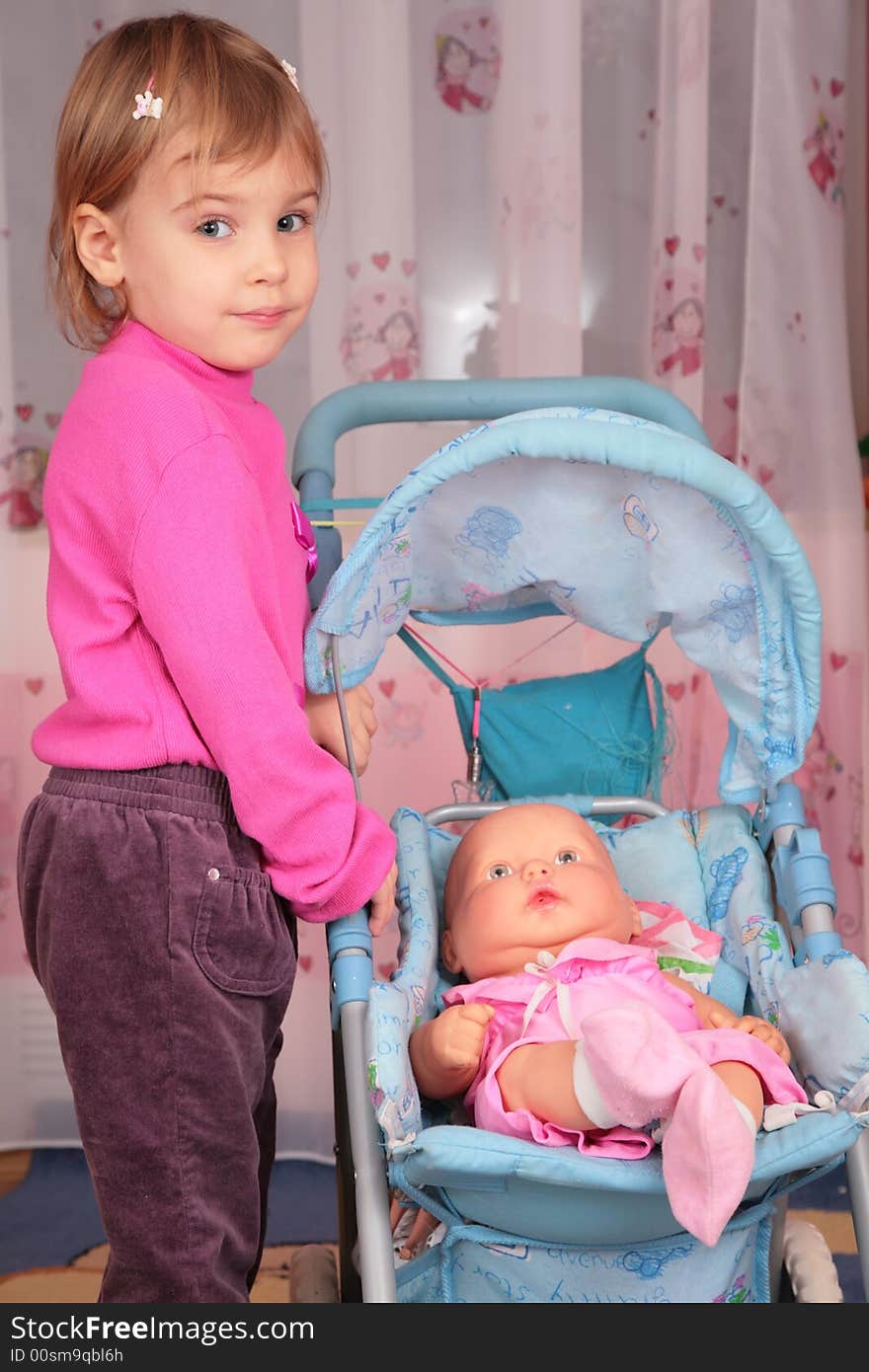 Small girl with doll in carriage 2