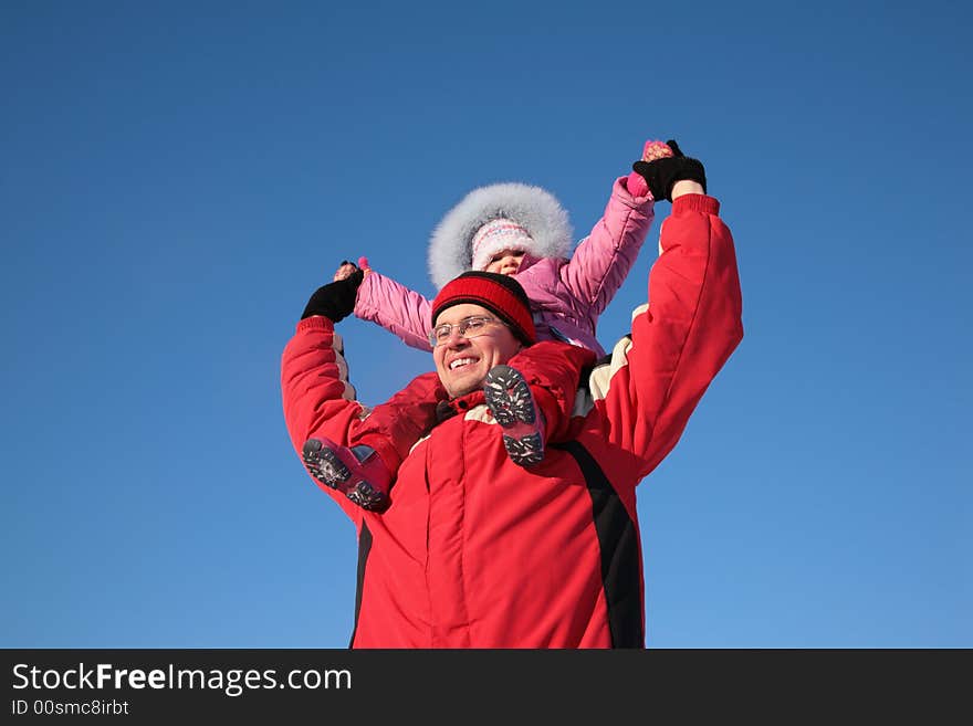 Father with child on shoulders in the winter 2