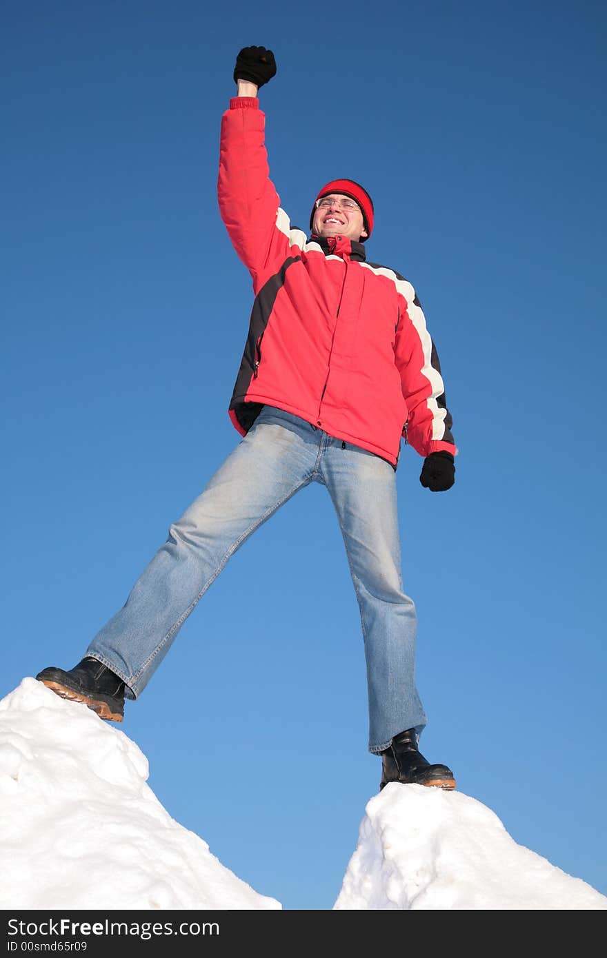 Man In Red Jacket On Top Of Snow Hill