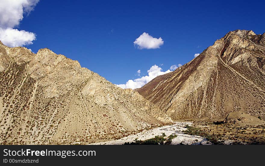 It is mountain and the blue sky. location is in Tibet of China. It is mountain and the blue sky. location is in Tibet of China.