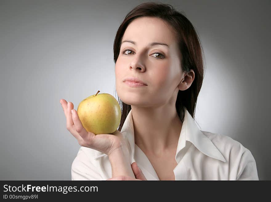 A woman with a apple. A woman with a apple