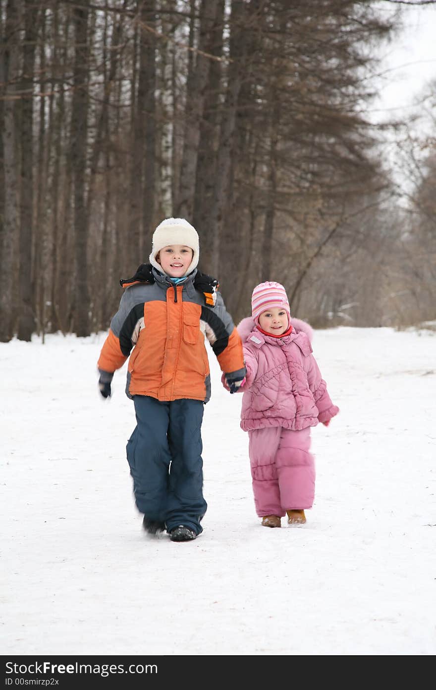 Brother and sister walk in park