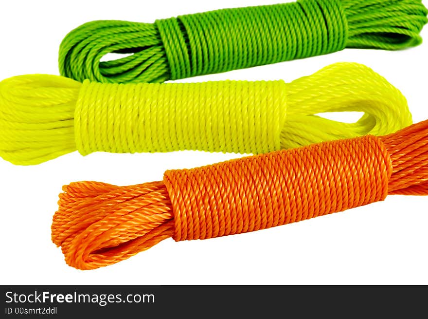 Color ropes. Focus on ornge rope. Isolated on white.