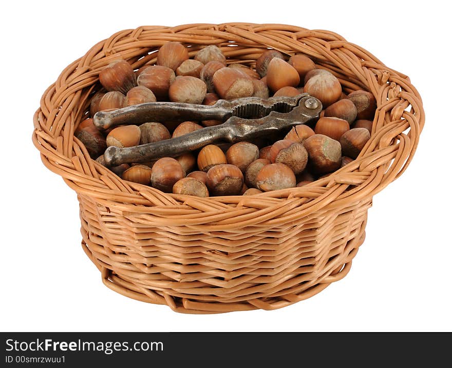 Basket of whole hazelnuts with cracker, isolated on white.