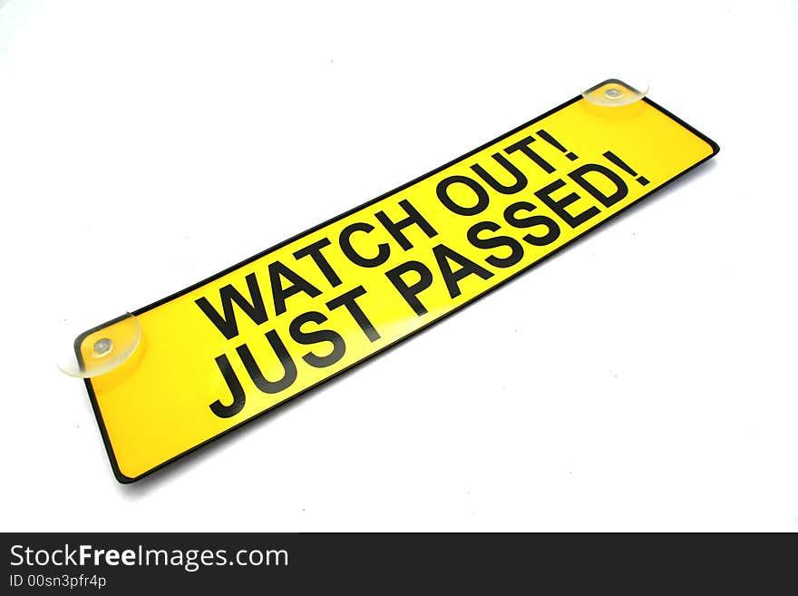 A bright yellow warning sign for use of a new driver. isolated on a white background. A bright yellow warning sign for use of a new driver. isolated on a white background