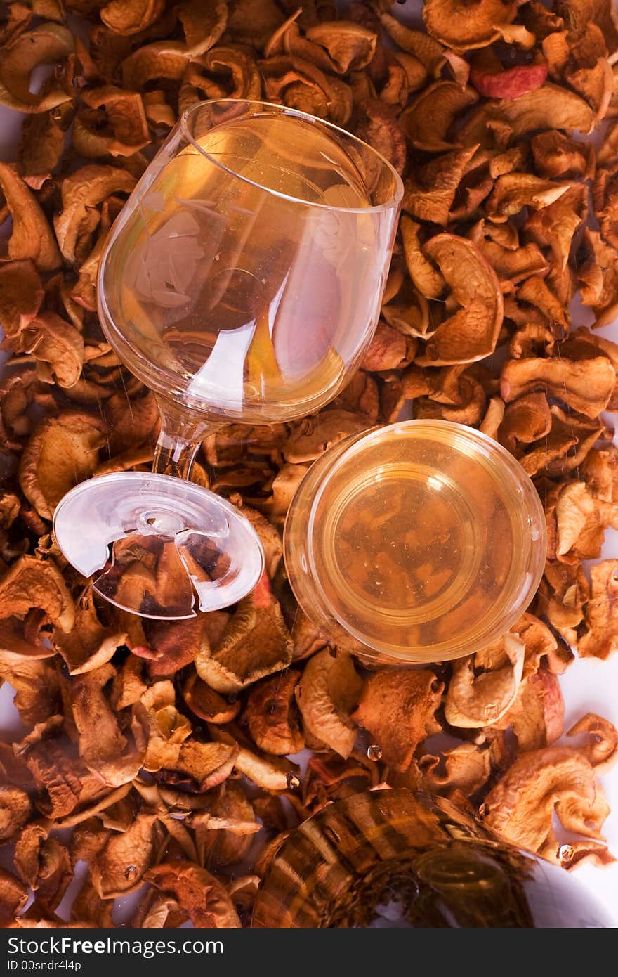 Wine in glasses against a background of dried apples