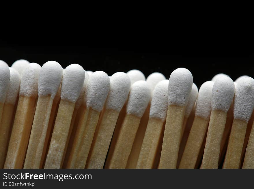 A row of matches isolated on black