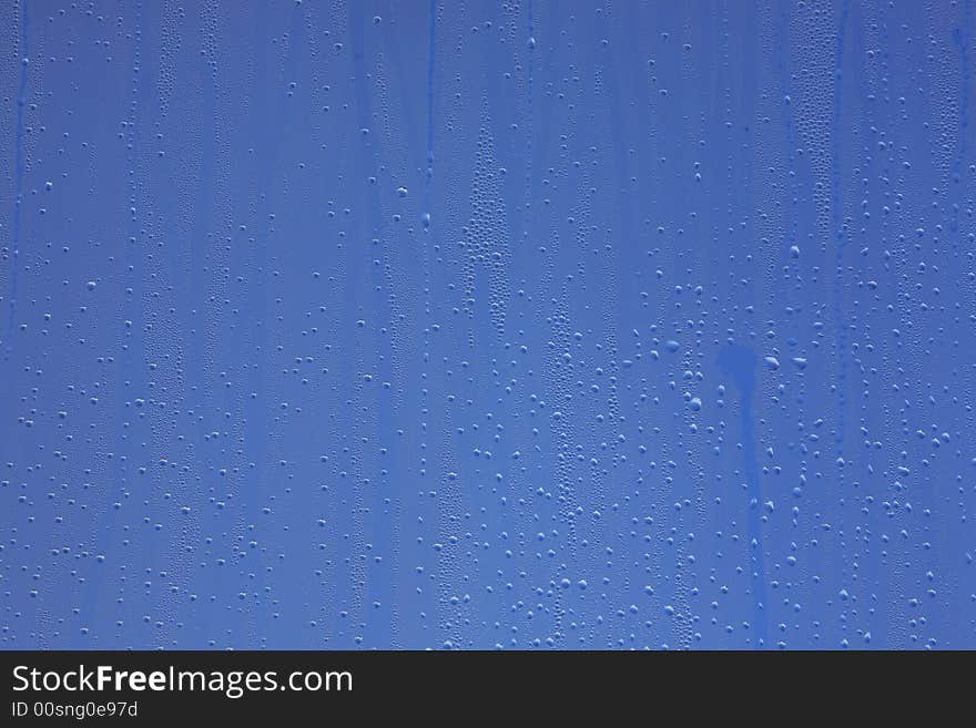 Drops on window with blue background