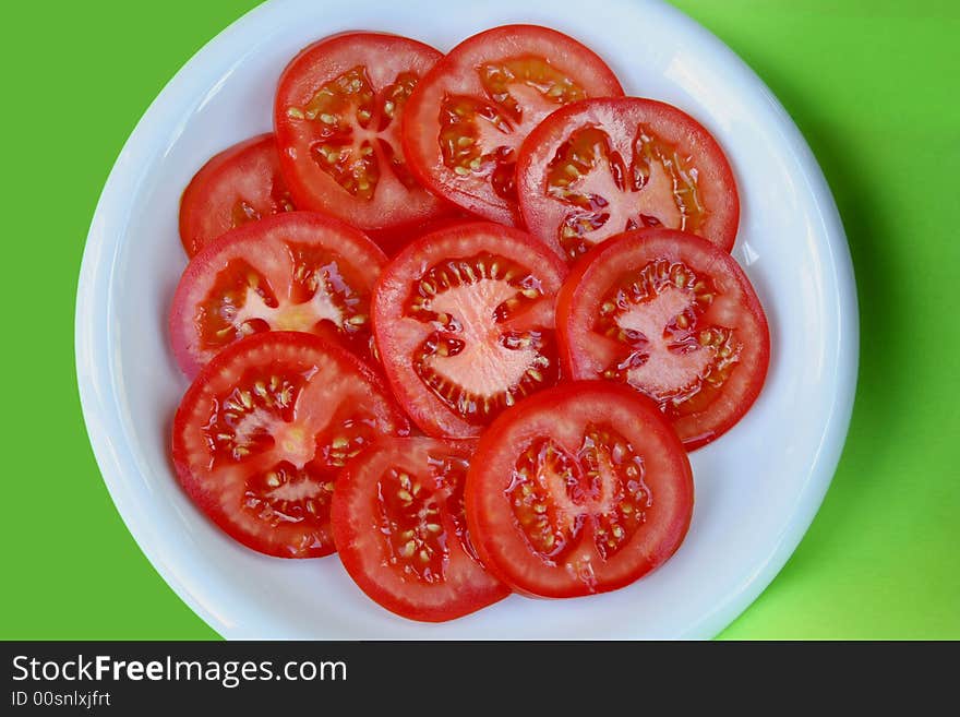 Fresh sliced tomato on a white plate. Fresh sliced tomato on a white plate