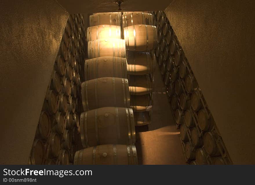 Oak Wine barrels stacked high in cellar. Oak Wine barrels stacked high in cellar