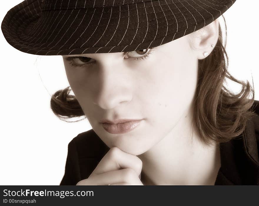 Wary teen wearing a pin-striped fedora hat.  Sepia toned, isolated on white.