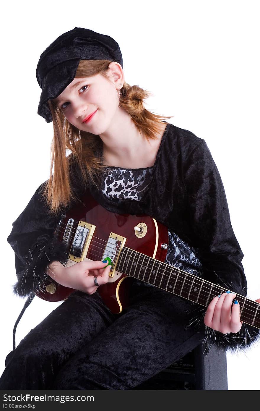 Preteen playing her electric guitar.  Isolated on white. Preteen playing her electric guitar.  Isolated on white.