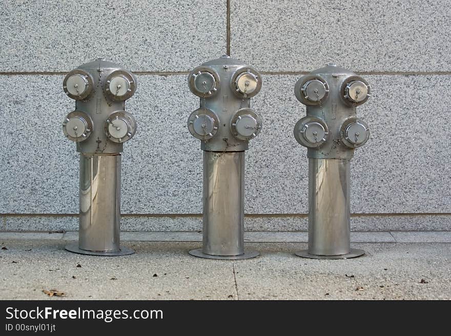 Architectural detail shot of ornamental fire department connections for a modern skyscraper office building.