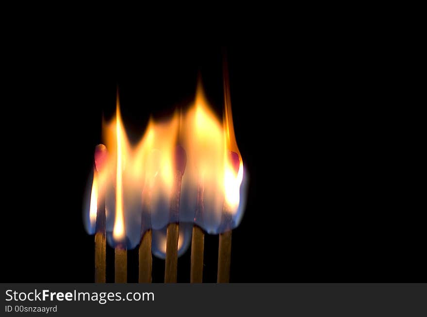 Six matches burning isolated on black. Six matches burning isolated on black