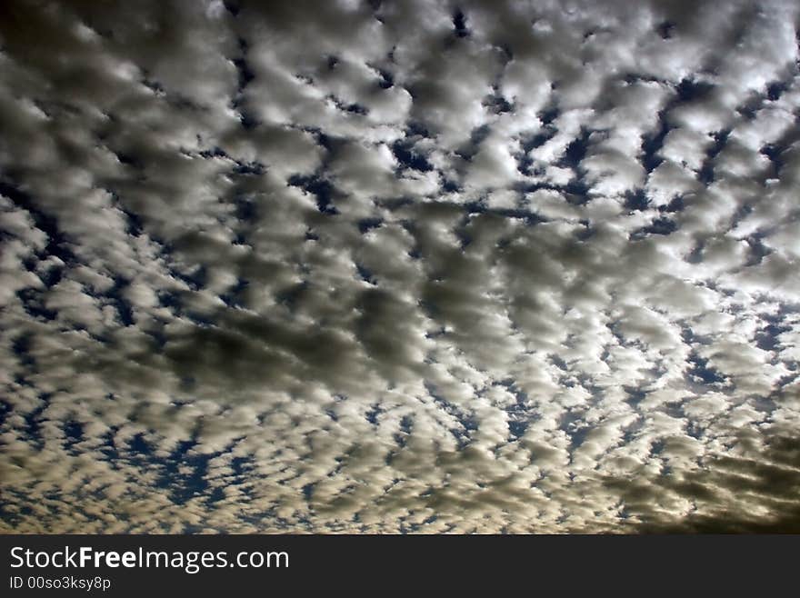 Teared up clouds with blue sky in the background. Teared up clouds with blue sky in the background.