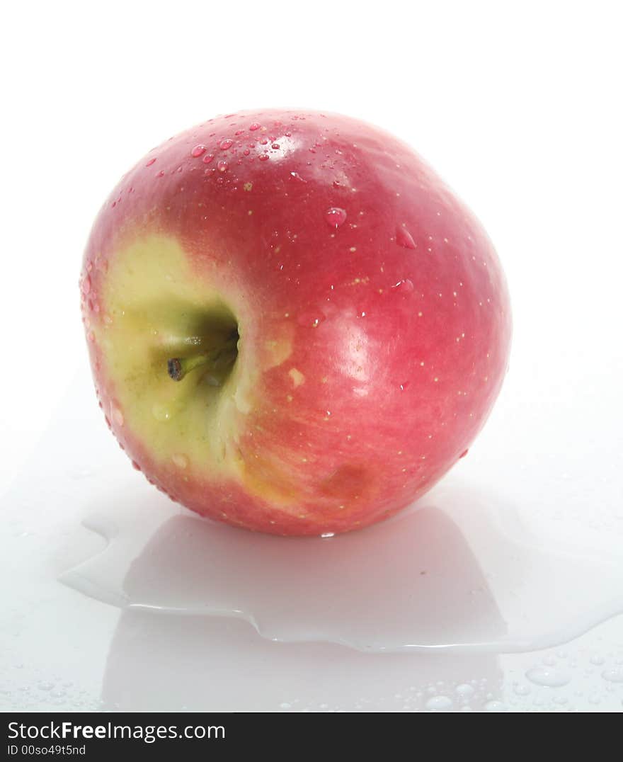 Wet red apple on a white background