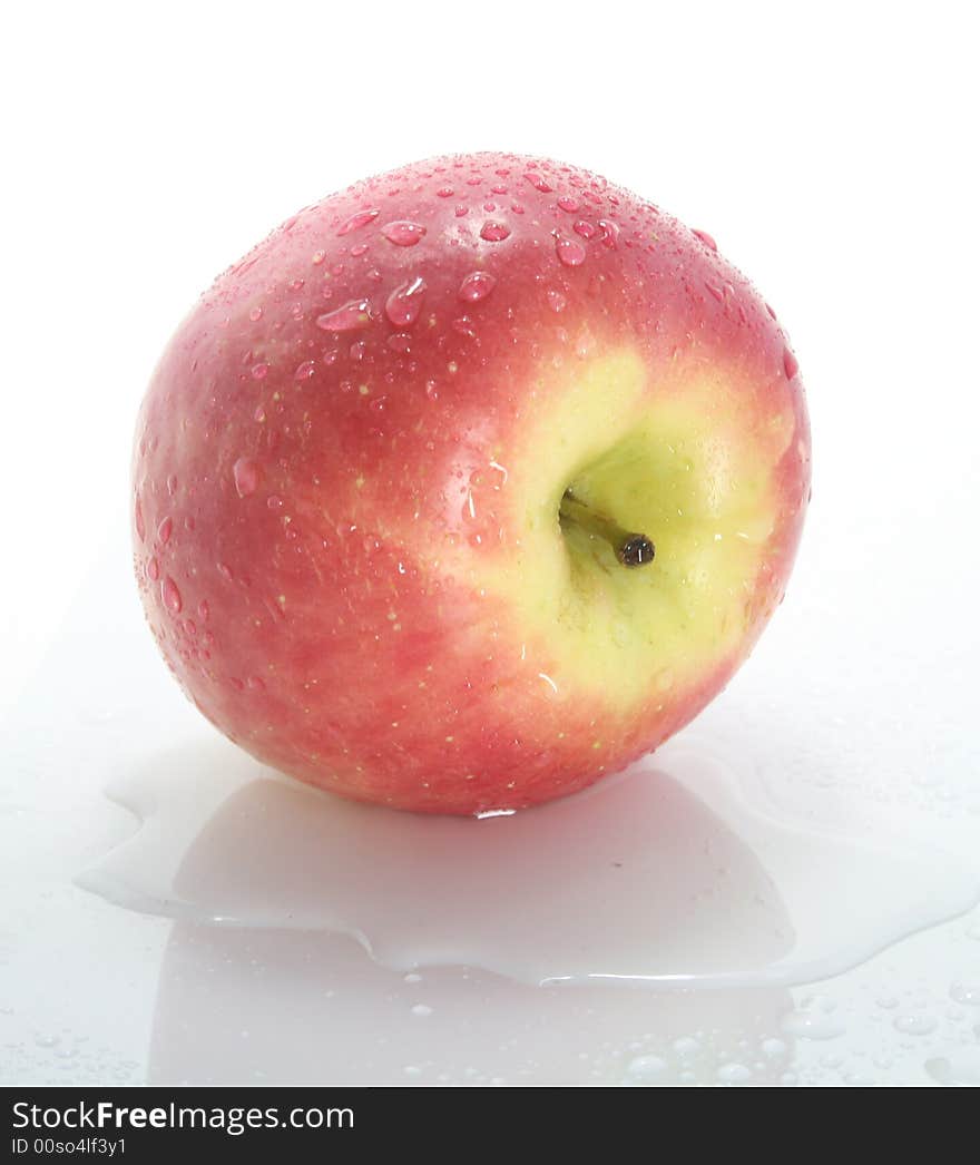 Wet red apple on a white background