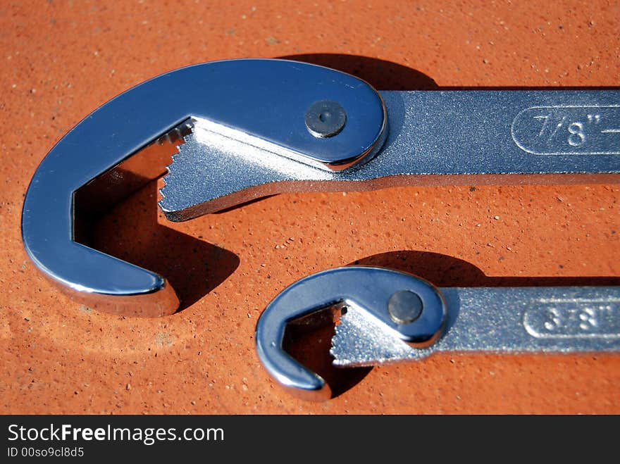 Two chrome metal monkey wrenches