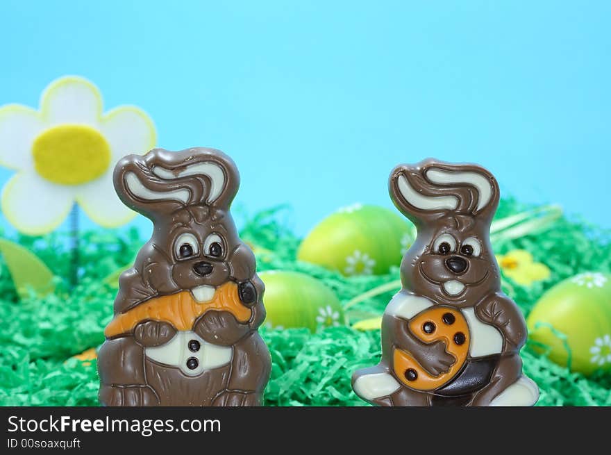 Two chocolate easter bunnies on blue