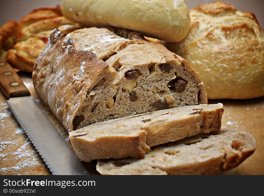 Loaves of bread on a wooden cutting board. Loaves of bread on a wooden cutting board