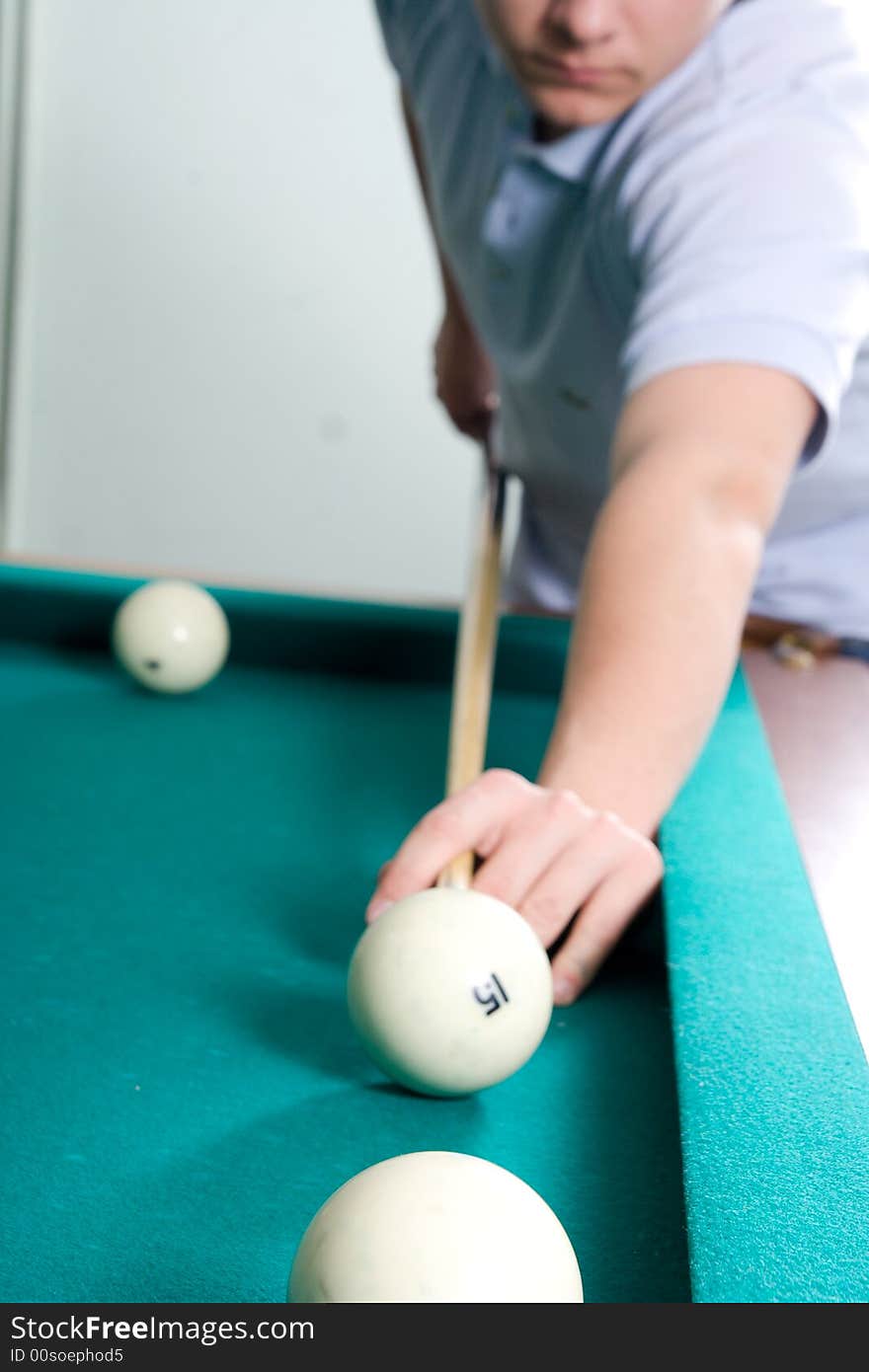 The guy plays billiards (focus on ball)