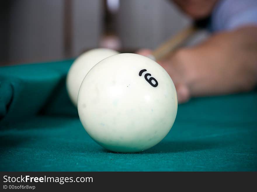 The young guy plays billiards. The young guy plays billiards