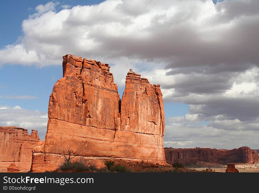 View of the red rock formations in Arches National Park with blue sky�s and clouds. View of the red rock formations in Arches National Park with blue sky�s and clouds