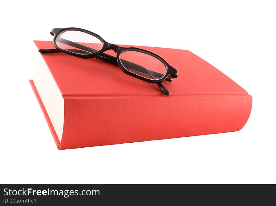 Red book and black glasses on a white background