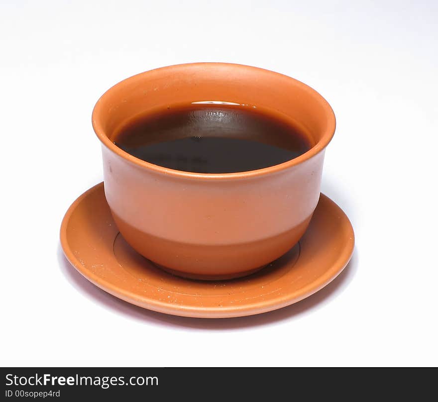 A small cup of coffee on a white background