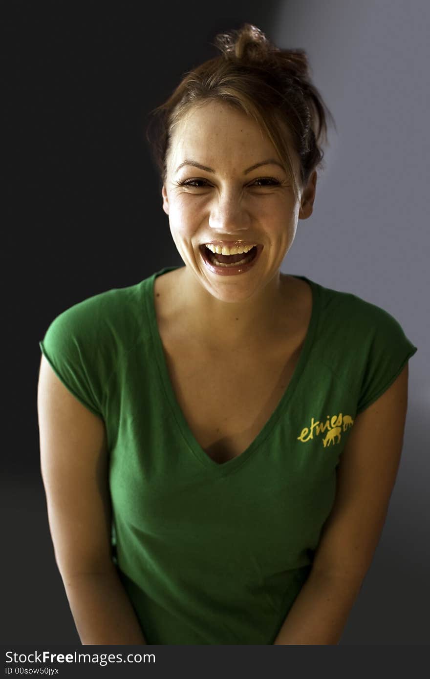 Woman smiling while kneeling on a sheet. Woman smiling while kneeling on a sheet