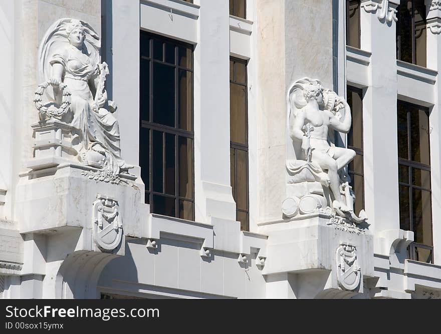 Woman and man statues made of white stone