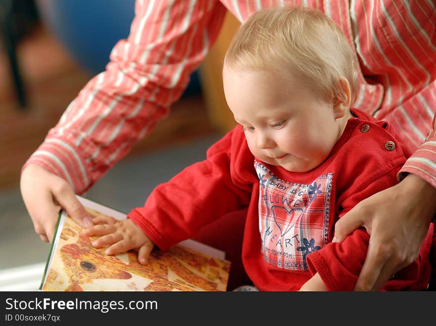 Child with its mammy and book