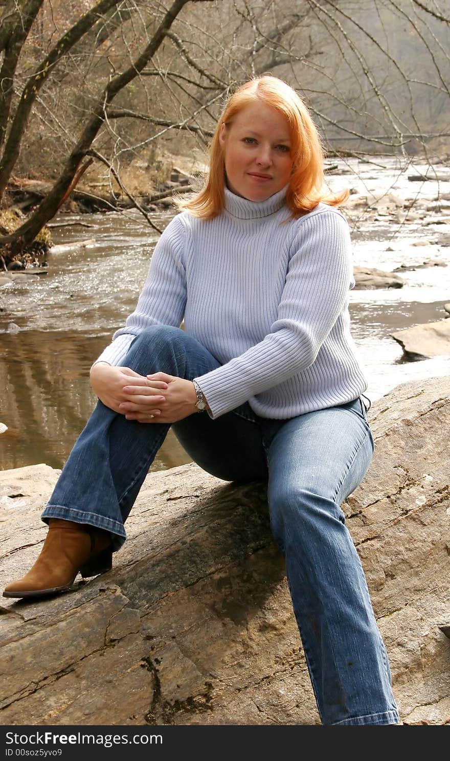 Woman posing outside on a rock. Woman posing outside on a rock