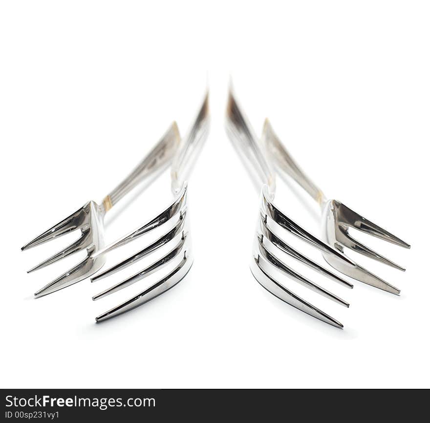 Four forks isolated on white. High key. Handle is out of focus