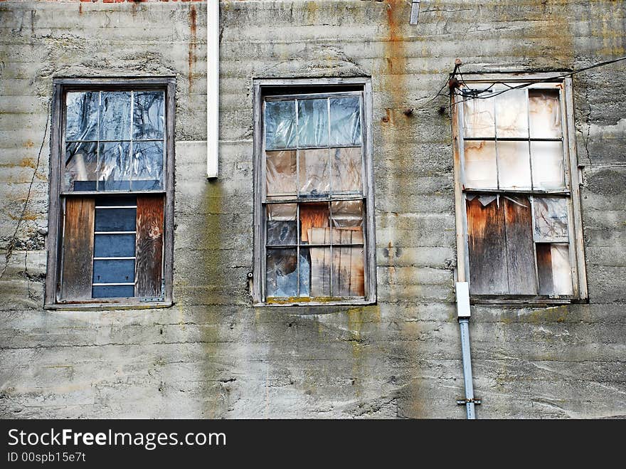 Decrepit and cluttered windows on old warehouse. Decrepit and cluttered windows on old warehouse