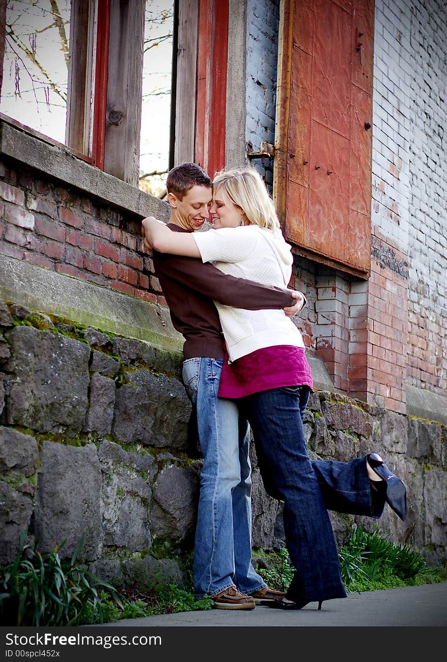 Young couple hugging in an industrial part of the city