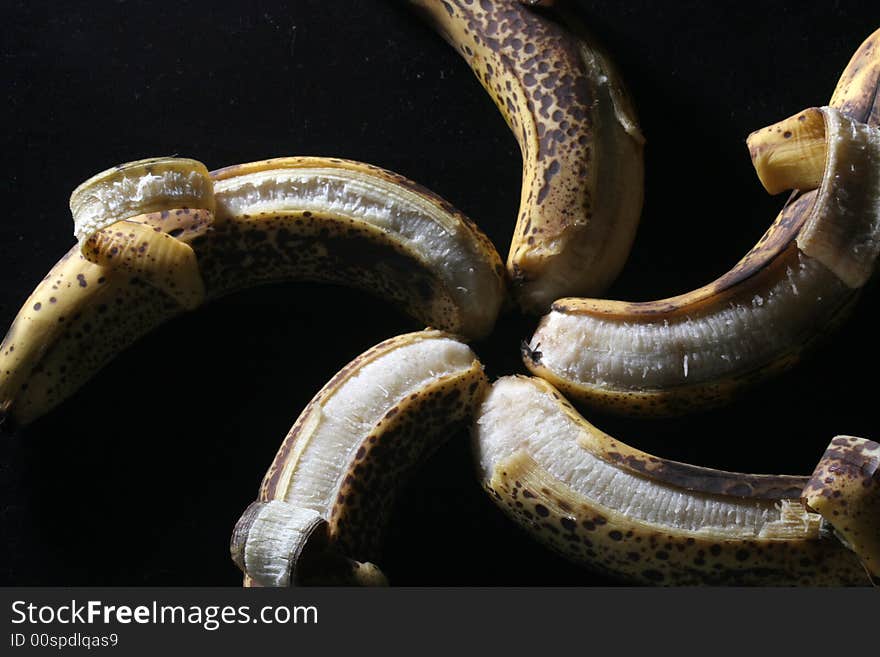 Five bananas in a star pattern isolated against a black background. Five bananas in a star pattern isolated against a black background