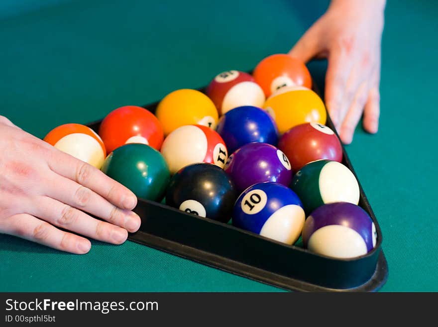 Color billiards balls with man hands