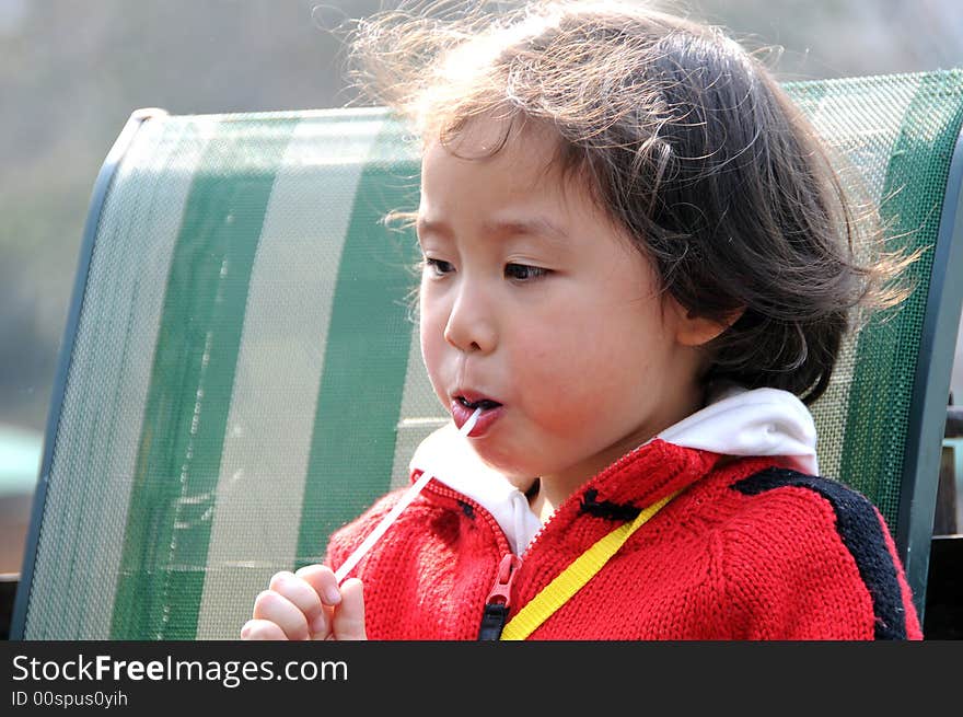 A beautiful girl in red，and eat the sugar. A beautiful girl in red，and eat the sugar